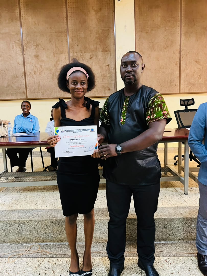 Student standing with an official after receiving a certificate